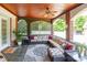 Inviting screened porch features comfortable seating, ceiling fan, and brick columns for a relaxing outdoor experience at 572 W Shiloh Unity Rd, Lancaster, SC 29720