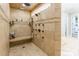 Large walk-in shower featuring multiple shower heads, built-in bench, and decorative tile accents at 572 W Shiloh Unity Rd, Lancaster, SC 29720