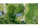 An aerial perspective shows the property's expansive yard, deck, patio, and driveway, nestled within a lush landscape at 5914 Mt Holly Huntersville Rd, Charlotte, NC 28216