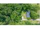 An aerial view of a home surrounded by lush trees in a serene, wooded neighborhood at 5914 Mt Holly Huntersville Rd, Charlotte, NC 28216