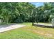Backyard with a wooden deck and a concrete pad provides ample outdoor space at 5914 Mt Holly Huntersville Rd, Charlotte, NC 28216