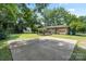 Wide-angle view of the house's backyard showcasing a wooden deck, patio, and lush greenery at 5914 Mt Holly Huntersville Rd, Charlotte, NC 28216