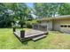 Backyard featuring a wooden deck and mature trees, perfect for outdoor entertaining and relaxation at 5914 Mt Holly Huntersville Rd, Charlotte, NC 28216