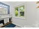Modern bathroom featuring a stylish vanity, large window, and contemporary design at 5914 Mt Holly Huntersville Rd, Charlotte, NC 28216