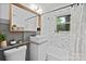 Modern bathroom with a sink, vanity, mosaic tile, and bathtub with a window for natural light at 5914 Mt Holly Huntersville Rd, Charlotte, NC 28216