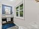 Modern bathroom featuring a stylish vanity, large window, and contemporary design at 5914 Mt Holly Huntersville Rd, Charlotte, NC 28216
