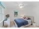 Well-lit bedroom with a ceiling fan, large window, and modern furniture at 5914 Mt Holly Huntersville Rd, Charlotte, NC 28216