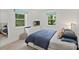 Comfortable bedroom with plush bed, bright windows, and neutral tones at 5914 Mt Holly Huntersville Rd, Charlotte, NC 28216