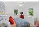 Bright bedroom featuring a ceiling fan, two windows, and modern decor for a cozy atmosphere at 5914 Mt Holly Huntersville Rd, Charlotte, NC 28216
