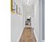 Hallway featuring hardwood floors and colorful paintings at 5914 Mt Holly Huntersville Rd, Charlotte, NC 28216