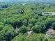 Aerial view highlighting a cul-de-sac location with lush trees, offering privacy and seclusion at 5955 Mountain Point Ln, Charlotte, NC 28216