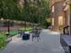 Backyard featuring a patio area with seating, a grill, firepit and string lights for ambiance at 5955 Mountain Point Ln, Charlotte, NC 28216