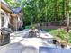Open-air backyard patio with an outdoor dining set and grill for entertaining at 5955 Mountain Point Ln, Charlotte, NC 28216