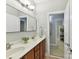Bathroom with a double vanity, wall to wall mirror and bright lighting at 5955 Mountain Point Ln, Charlotte, NC 28216