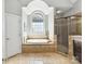 Luxurious bathroom features a soaking tub under a large window and a separate glass-enclosed shower at 5955 Mountain Point Ln, Charlotte, NC 28216