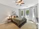 Cozy bedroom featuring a metal bed frame, neutral-toned walls, and plenty of natural light at 5955 Mountain Point Ln, Charlotte, NC 28216