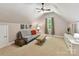 Cozy bonus room with neutral walls, a ceiling fan, ample natural light and comfortable seating at 5955 Mountain Point Ln, Charlotte, NC 28216