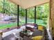 Outdoor covered patio featuring stone pillars, seating and a view of the expansive backyard at 5955 Mountain Point Ln, Charlotte, NC 28216