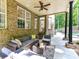 Relaxing covered patio area with comfortable seating and view of the lush backyard at 5955 Mountain Point Ln, Charlotte, NC 28216