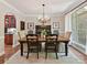 Elegant dining room with a wooden table, chandelier, and large window, perfect for gatherings at 5955 Mountain Point Ln, Charlotte, NC 28216