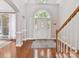 Bright foyer features a hardwood floor, arched entryway, staircase, and natural light from the front door at 5955 Mountain Point Ln, Charlotte, NC 28216