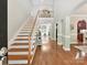 Elegant foyer showcasing hardwood floors, a staircase, and an open gallery with natural light at 5955 Mountain Point Ln, Charlotte, NC 28216