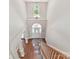 Grand foyer with soaring ceilings, a large window, and hardwood floors leading to the home's interior at 5955 Mountain Point Ln, Charlotte, NC 28216
