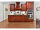 Gourmet kitchen featuring wooden cabinetry, granite countertops, stainless steel appliances, and hardwood floors at 5955 Mountain Point Ln, Charlotte, NC 28216