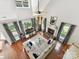 Open-concept living room with high ceilings, fireplace, large windows, neutral tones, and hardwood flooring at 5955 Mountain Point Ln, Charlotte, NC 28216