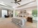 Serene main bedroom featuring a fireplace, sitting area, ceiling fan, and large windows, ensuring maximum comfort at 5955 Mountain Point Ln, Charlotte, NC 28216