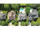 Neighborhood aerial view showcases a backyard pool and mature trees nestled among well-maintained homes in a desirable location at 606 Vega Nw St, Concord, NC 28027
