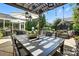 Outdoor patio with a large dining table, hanging lanterns, and lounge area near the pool at 606 Vega Nw St, Concord, NC 28027