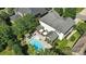 Aerial view of a serene backyard with a swimming pool, comfortable seating, and a screened-in porch perfect for outdoor living at 606 Vega Nw St, Concord, NC 28027