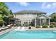 Inviting backyard featuring a sparkling pool, lounge chairs, and an outdoor living area perfect for relaxation at 606 Vega Nw St, Concord, NC 28027