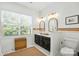Bathroom with double vanity, modern lighting, and marble floors at 606 Vega Nw St, Concord, NC 28027