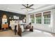 Bedroom featuring a dark accent wall, bench, and three large windows offering natural light at 606 Vega Nw St, Concord, NC 28027
