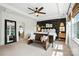 Spacious primary bedroom boasting dark accent wall, bench, and large windows for natural light at 606 Vega Nw St, Concord, NC 28027