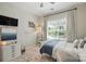 Bedroom features a ceiling fan, window overlooking the backyard, and a light neutral color palette at 606 Vega Nw St, Concord, NC 28027