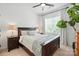 Bedroom with a wooden bed frame, natural light, and neutral colored walls at 606 Vega Nw St, Concord, NC 28027