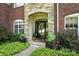Elegant front entrance featuring a stone archway, decorative plants, and a welcoming front door at 606 Vega Nw St, Concord, NC 28027