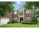 Charming brick home with stone accents, a well-manicured lawn, and beautiful landscaping at 606 Vega Nw St, Concord, NC 28027