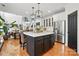 Kitchen features a kitchen island with seating, stainless steel appliances, and an open floor plan at 606 Vega Nw St, Concord, NC 28027