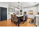Bright kitchen features a kitchen island with seating, pendant lighting, and white cabinets at 606 Vega Nw St, Concord, NC 28027