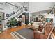 Open living room with a staircase, fireplace, and view into kitchen area, offering a spacious and stylish design at 606 Vega Nw St, Concord, NC 28027
