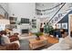 Open-concept living room with a fireplace, built-in shelves, and a view of the staircase at 606 Vega Nw St, Concord, NC 28027