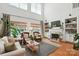 Bright living room featuring large windows, a cozy seating arrangement, and a fireplace at 606 Vega Nw St, Concord, NC 28027