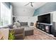 Comfortable living room with sectional sofa, patterned rug, and large-screen television at 606 Vega Nw St, Concord, NC 28027