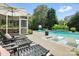 Luxury backyard oasis featuring a sparkling pool, lounge chairs, and a screened-in porch at 606 Vega Nw St, Concord, NC 28027