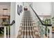 Elegant staircase features a striped runner, white railings, and a view of the home's interior at 606 Vega Nw St, Concord, NC 28027
