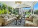 Inviting sunroom with wicker furniture, plants, and view of the fountain and pool at 606 Vega Nw St, Concord, NC 28027